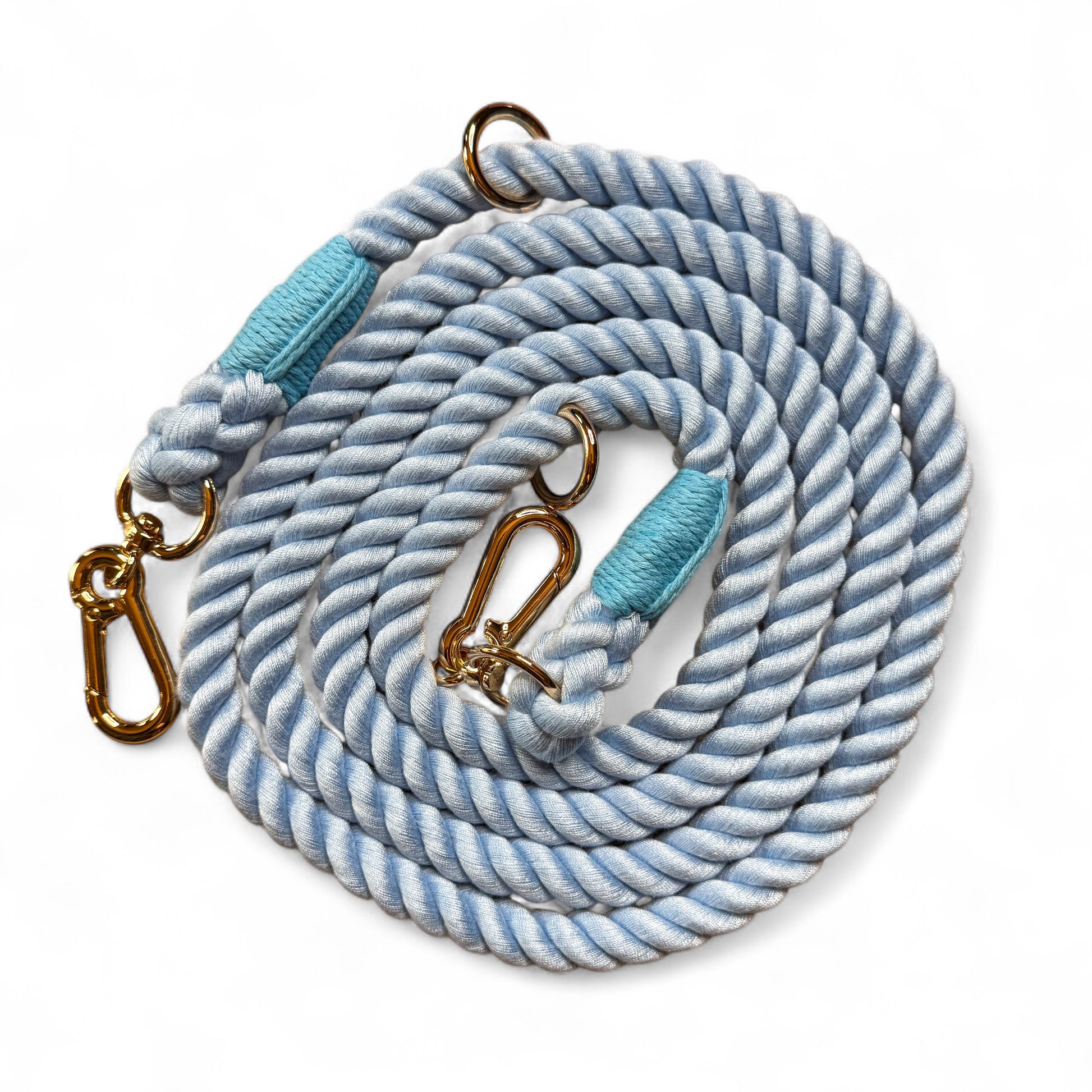 Blue 7ft multi-use rope dog lead coiled on white background, showing durable rope texture and metal clips